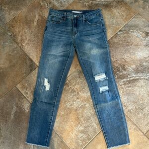 Tractr distressed jean. Zipper with button fly. Mid rise. Raw edge bottom